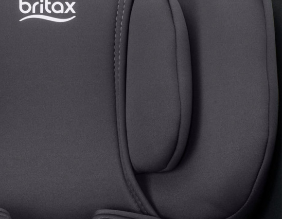 The headrest of a dark grey car seat displaying the Britax logo.