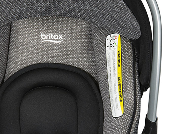 The top portion of an infant car seat with the Britax logo. The car seat padding is light grey with tiny white dots.