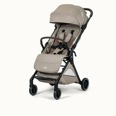 A tan stroller with a brown bumper bar, a canopy, a storage basket, and the Britax logo on the leg rest.