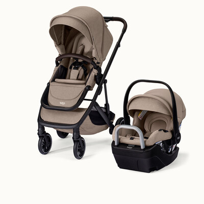 A tan stroller and infant car seat on a car seat base. The stroller has a canopy and a bumper bar.