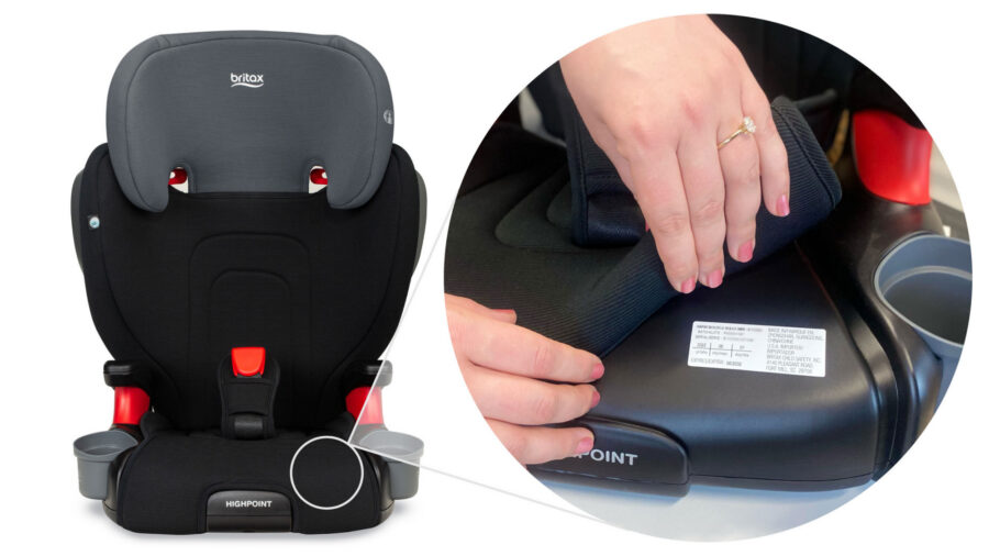 Person lifting up the car seat cover on a belt-positioning booster to reveal the serial label hidden underneath it