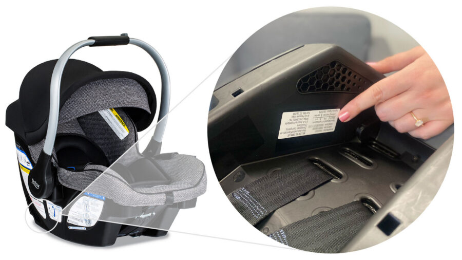 Hand pointing to a label located underneath the infant car seat.
