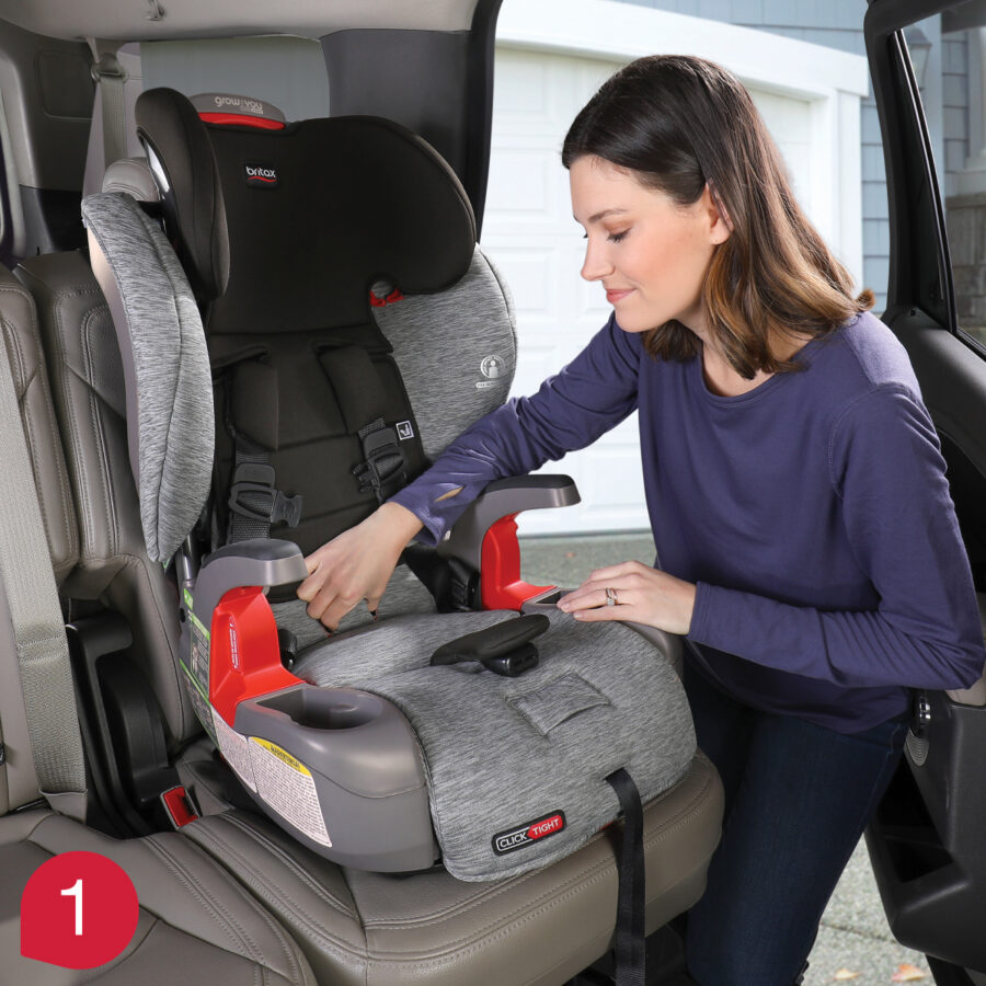 Mother demonstrating how to squeeze and open the car seat