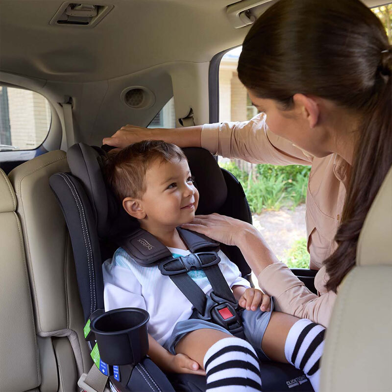 Woman adjusting harness height for growing child