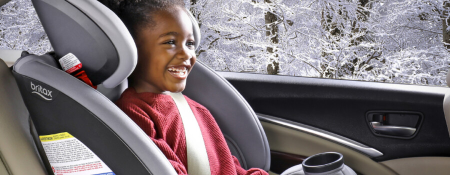 A child sitting in a forward-facing car seat.