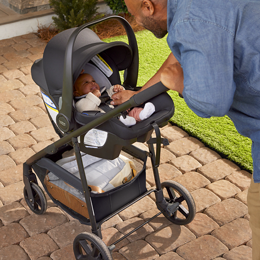 A man pushing a stroller with a baby.