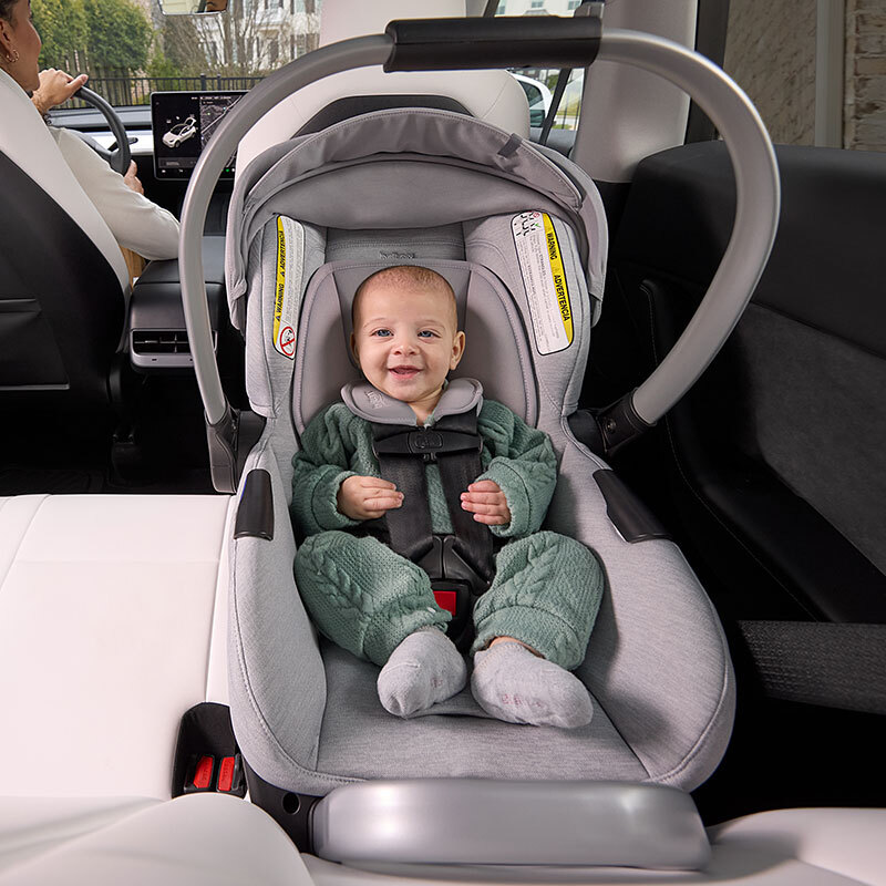 A baby in a rear-facing car seat.