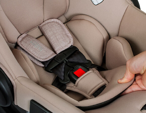 Someone feeling the plush-looking inserts of an infant car seat.