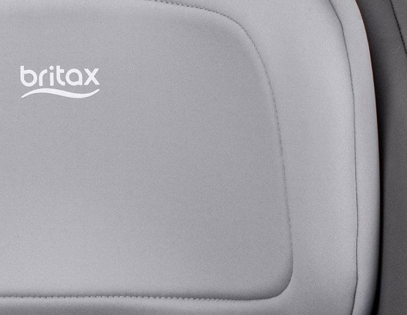 Closeup view of grey car seat headrest padding with the Britax logo.