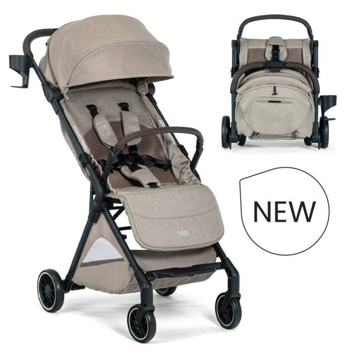 New. A tan stroller with a brown bumper bar, a canopy, a storage basket, a cup holder, and the Britax logo.